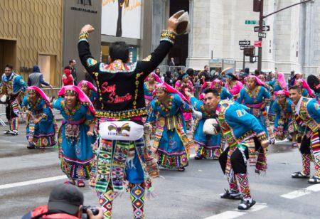 hispanic heritage parade in NYC with people dressed in festive latin costumes