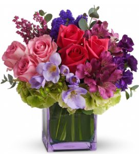 red and pink roses with other pink and purple floral accents