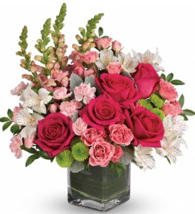 Stunning roses, delicate alstroemeria and dramatic snapdragons are hand-delivered in a classic cube vase lined with a green leaf 