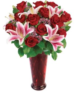 bouquet includes twelve premium long stemmed Ecuadorian red roses, along with two stems of stargazer lilies, accented with wax flower in a ruby red vase