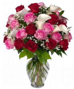 Passionate premium long stem red roses, romantic premium long stem pink roses, and stunningly beautiful white Calla lilies, hand-designed in a premium clear glass vase.