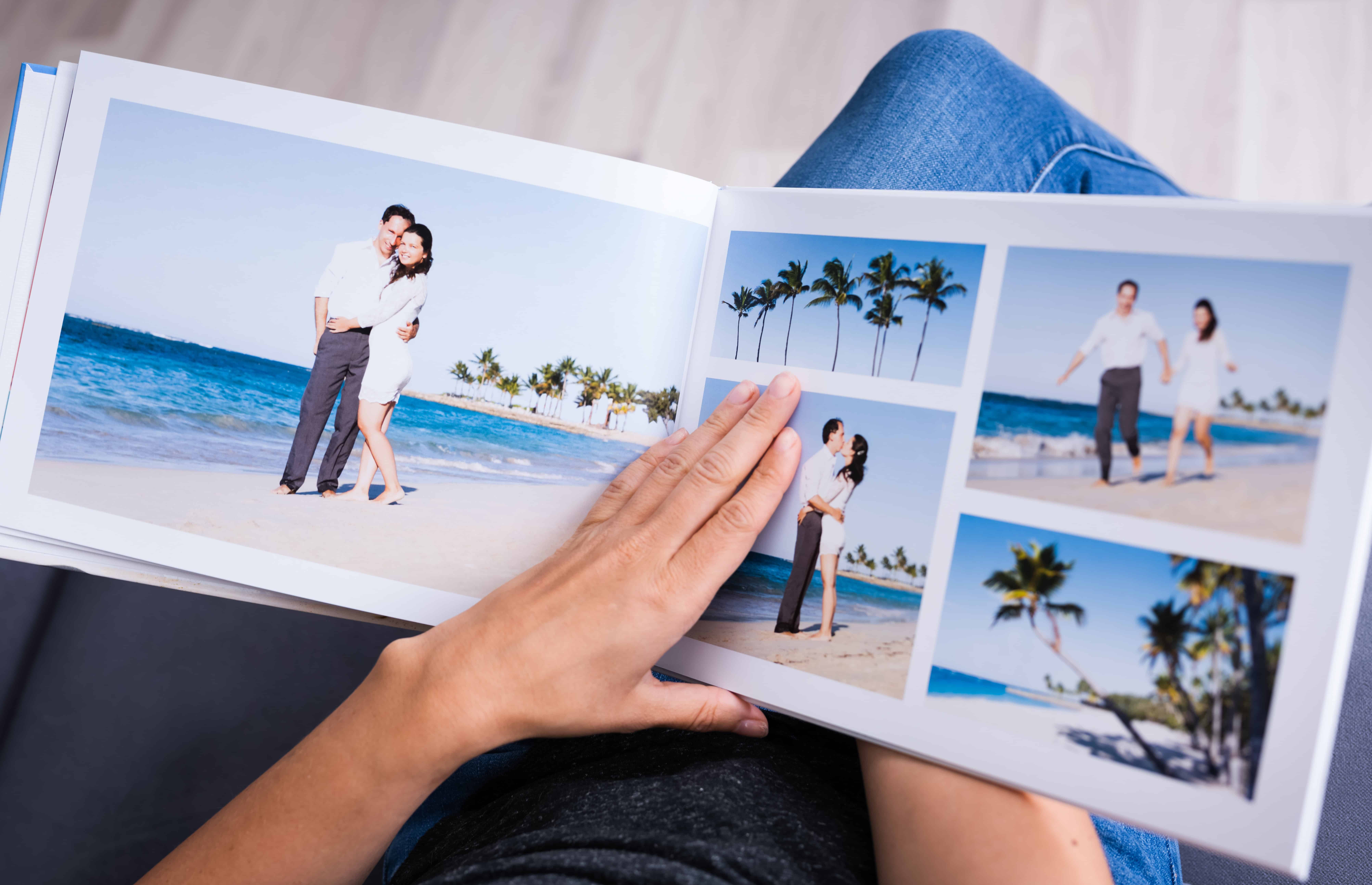 open photo book with pics of couple on beach